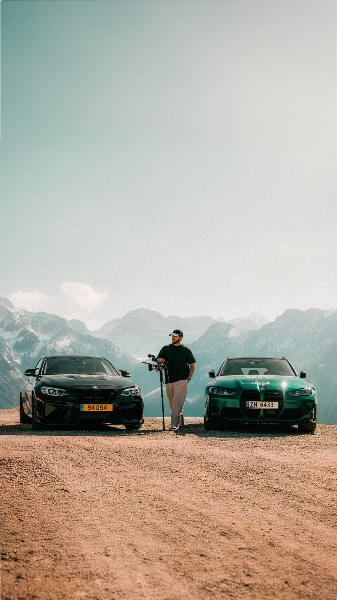 On location, camera rig between two cars in the mountains
